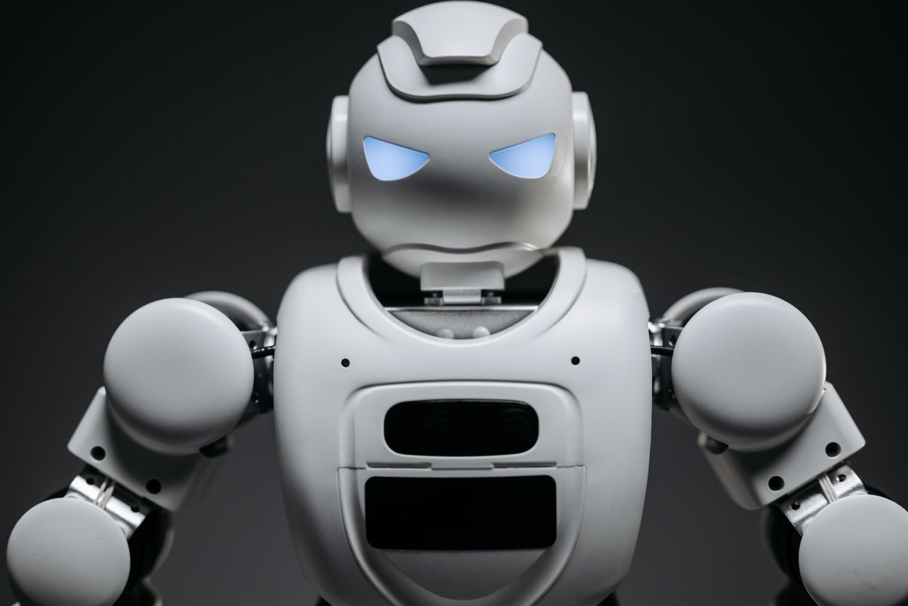 services-02 Detailed studio shot of a modern robotic toy with a dark background, showcasing technological design.