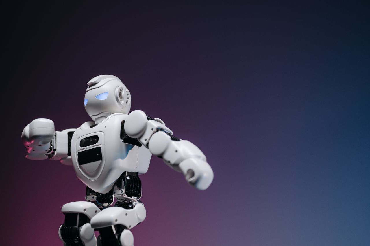 home-hero-bg Close-up of a futuristic robotic toy against a gradient background, symbolizing innovation and technology.