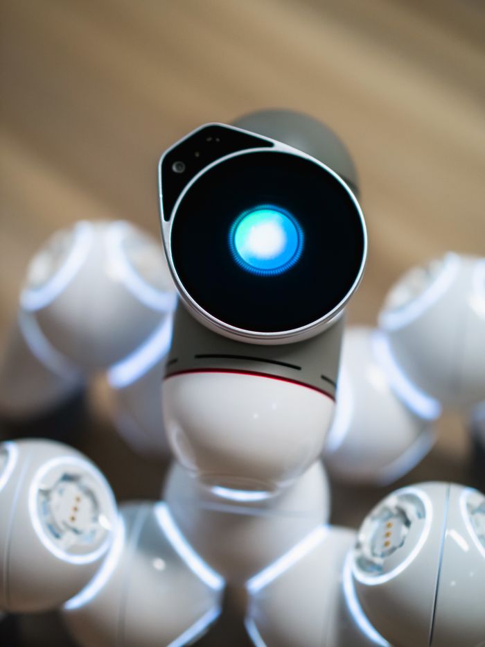 home-services-02 Close-up view of a humanoid robot with a glowing blue eye, symbolizing advanced technology.